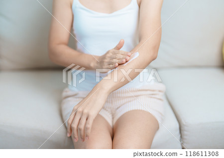 Skin care lotion and Skin body cream Moisturizing, Sunscreen and Healthy Daily Routine concepts. Beauty Woman applying moisturizing skincare cream on arm and body at home 118611308