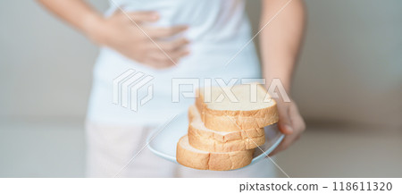 Gluten intolerance, Gluten free and celiac disease or wheat allergy concept. woman hold Bread and having abdominal pain after eat gluten. stomach ache, Nausea, Bloating, Gas, Diarrhea and Skin rash Gluten intolerance, Gluten free and celiac disease or wheat allergy concept. woman hold Bread and having abdominal pain after eat gluten. stomach ache, Nausea, Bloating, Gas, Diarrhea and Skin rash 118611320