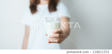 Milk drink and Daily Routine concept. Young woman Drinking milk with high calcium and nutrition at home, woman holding soy milk on glass with protein. Healthy, wellness and happy lifestyle Milk drink and Daily Routine concept. Young woman Drinking milk with high calcium and nutrition at home, woman holding soy milk on glass with protein. Healthy, wellness and happy lifestyle 118611352
