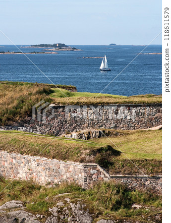 Yacht with sails along coast of Finland in Baltic Sea. Scandinavia and nature. Sailing and recreation.  118611579