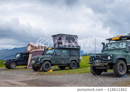Cars parked in the southern part of Iceland. 4x4 off-road vehicles against the blue sky 118611862