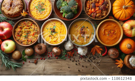 The Harvest Bounty Feast. A rustic wooden table laden with an array of autumnal dishes, showcasing the season's bounty: roasted root vegetables, creamy pumpkin soup, and hearty apple crumble. 118612348
