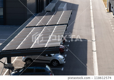Parking space with solar panels on a roof 118612574