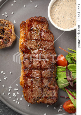 Grilled beef steak with garlic and sauce 118612664