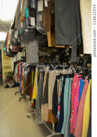Interior of an industrial warehouse with fabric rolls samples. Small business textile colorful warehouse. 118612914