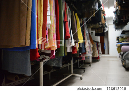 Interior of an industrial warehouse with fabric rolls samples. Small business textile colorful warehouse. 118612916