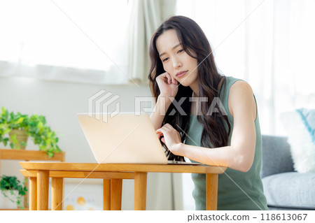 Woman using a computer worries 118613067