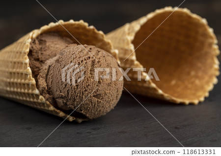 chocolate ice cream with chocolate chips on black slate 118613331