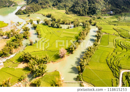 Aerial landscape in Quay Son river, Trung Khanh, Cao Bang, Vietnam with nature, green rice fields and rustic indigenous houses. Aerial landscape in Quay Son river, Trung Khanh, Cao Bang, Vietnam with nature, green rice fields and rustic indigenous houses. 118615253