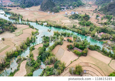 Aerial landscape in Quay Son river, Trung Khanh, Cao Bang, Vietnam with nature, green rice fields and rustic indigenous houses. Aerial landscape in Quay Son river, Trung Khanh, Cao Bang, Vietnam with nature, green rice fields and rustic indigenous houses. 118615285