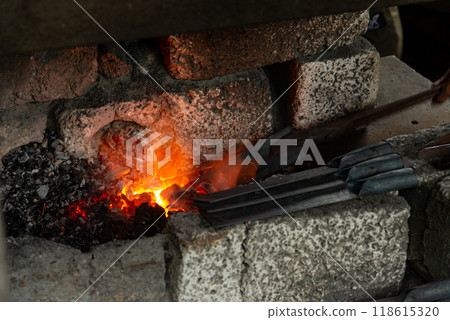 Orange light from charcoal stove burned to make a knife Orange light from charcoal stove burned to make a knife 118615320