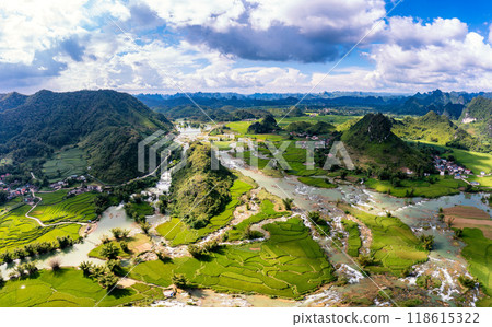 Aerial landscape in Quay Son river, Trung Khanh, Cao Bang, Vietnam with nature, green rice fields and rustic indigenous houses. Aerial landscape in Quay Son river, Trung Khanh, Cao Bang, Vietnam with nature, green rice fields and rustic indigenous houses. 118615322