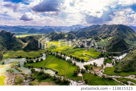 Aerial landscape in Quay Son river, Trung Khanh, Cao Bang, Vietnam with nature, green rice fields and rustic indigenous houses. Aerial landscape in Quay Son river, Trung Khanh, Cao Bang, Vietnam with nature, green rice fields and rustic indigenous houses. 118615323