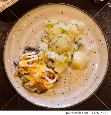 French meat with boiled potatoes served on plate. top view French meat with boiled potatoes served on plate. top view 118615632