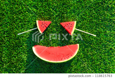 Summer fresh image of lollipop or ice cream shaped slice of watermelon on the grass background Summer fresh image of lollipop or ice cream shaped slice of watermelon on the grass background 118615763