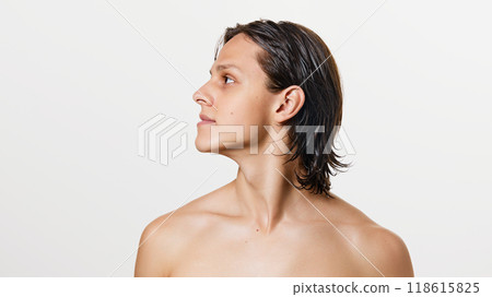 Portrait of young attractive brunette man with wet hair posing shirtless against white studio background. 118615825