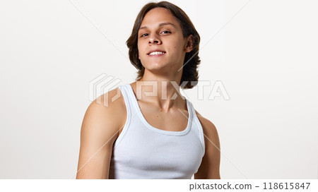 Photo of young confident man posing, confidently looking at camera against white studio background. Model with healthy, well-groomed hair. Photo of young confident man posing, confidently looking at camera against white studio background. Model with healthy, well-groomed hair. 118615847