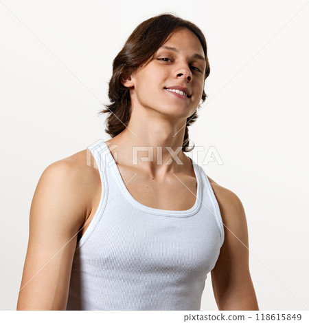 Photo of young confident man posing, confidently looking at camera against white studio background. Model with healthy, well-groomed hair. Photo of young confident man posing, confidently looking at camera against white studio background. Model with healthy, well-groomed hair. 118615849
