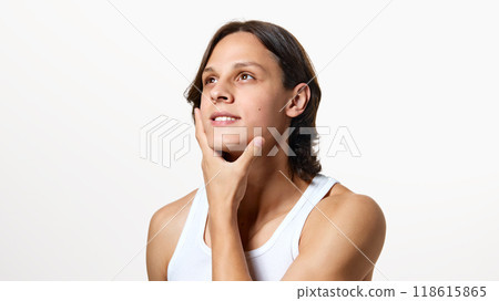 Portrait of young attractive man touching his soft skin on chin after shaving against white studio background. Portrait of young attractive man touching his soft skin on chin after shaving against white studio background. 118615865