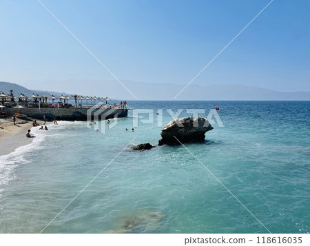 Rocky beach and crystal turquoise water of Ionian Sea in Albania. 118616035