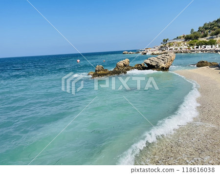 Rocky beach and crystal turquoise water of Ionian Sea in Albania. Rocky beach and crystal turquoise water of Ionian Sea in Albania. 118616038