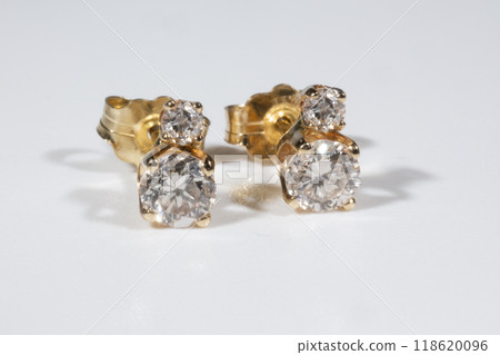 Diamond Earrings Isolated on White Background. Yellow Gold Diamond Earring Pair with 750 Stamp Denoting 18-Carat Yellow Gold. Diamond Earrings Isolated on White Background. Yellow Gold Diamond Earring Pair with 750 Stamp Denoting 18-Carat Yellow Gold. 118620096