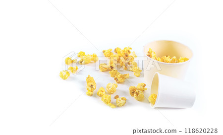 Isolated image of popcorn in paper cup set against a white background, showcasing the fluffy, golden kernels spilling over the edges, perfect for themes related to snacks, cinema, or casual dining. Isolated image of popcorn in paper cup set against a white background, showcasing the fluffy, golden kernels spilling over the edges, perfect for themes related to snacks, cinema, or casual dining. 118620228
