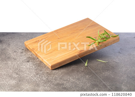 Empty cutting board with rosemary on a grey stone background. 118620840