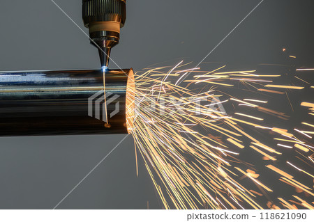 Close up scene the fiber laser cutting machine cut the stainless steel tube and sparkling light. 118621090