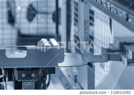 The high technology material handling at press brake bending machine by automatic robotic arm in the light blue scene. The high technology material handling at press brake bending machine by automatic robotic arm in the light blue scene. 118621092