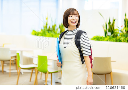 Female university student holding a file. Photo courtesy of Denpa Gakuen, Tokyo Electronics College. 118621468
