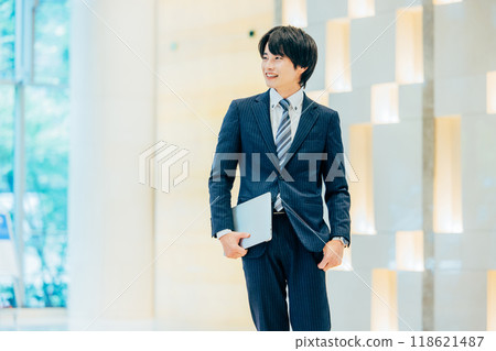 Businessman with a laptop, photo courtesy of Denpa Gakuen, Tokyo Electronics College 118621487