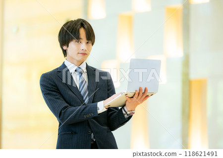 Businessman with a laptop, photo courtesy of Denpa Gakuen, Tokyo Electronics College 118621491