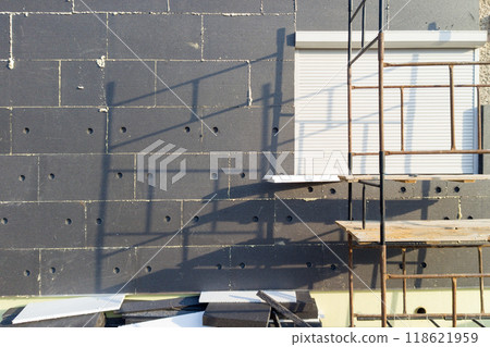 Scaffold and exterior insulation work on building facade 118621959