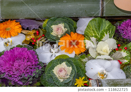 Hand-washing basin, chouzubachi in Japanese, at shrine, with flowers and petals. Kanazawa, Ishikawa, Japan 118622725