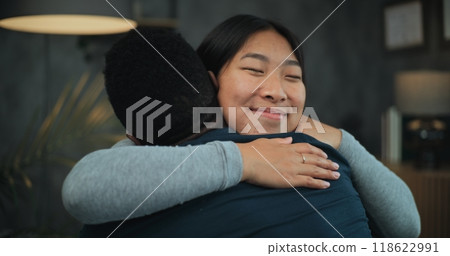 Happy multiethnic couple talk and hug after quarrel on couples therapy 118622991