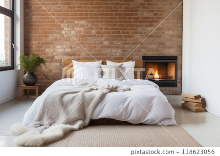 Bedroom with a fireplace and a brick wall in a loft style 118623056