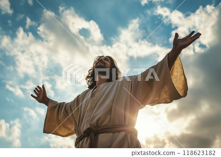 Jesus Christ in white clothes with outstretched arms against the sky as a symbol of Christianity 118623182