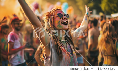 Happy young woman having fun and dancing in crowd at Holi festival of colors, summer party or music festival 118623189