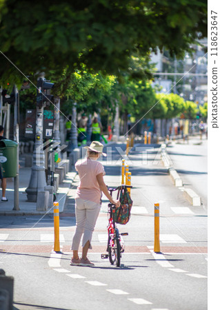 Woman with a bicycle on the street Woman with a bicycle on the street 118623647