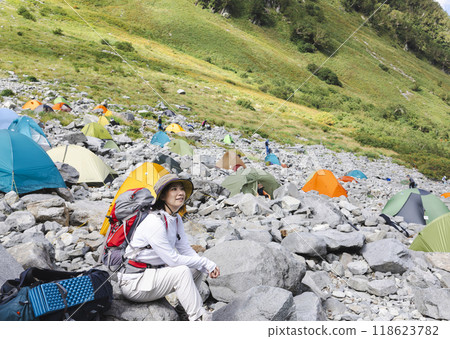 A woman hiking in a tent A woman hiking in a tent 118623782
