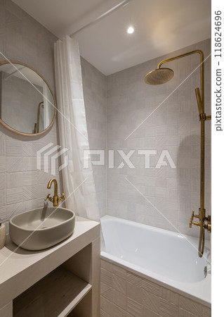 An Elegant and Modern Bathroom Featuring Stunning Gold Fixtures and Soothing, Relaxing Textures 118624696
