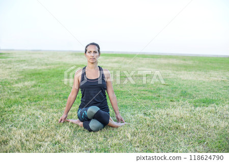 Woman looking through a red telescope at an outdoor observation deck... 118624790