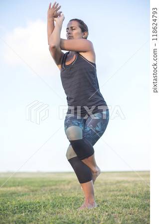 A Young woman doing yoga exercise outdoor 118624793