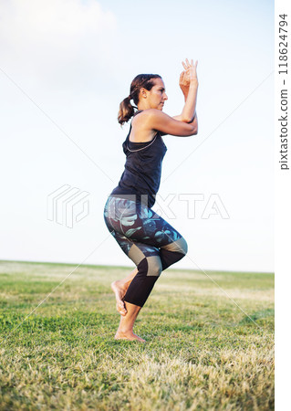 A Young woman doing yoga exercise outdoor 118624794