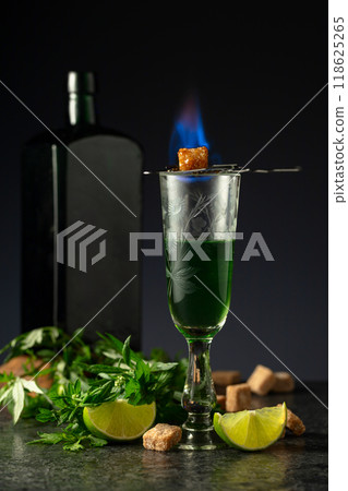 Burning sugar on a glass with absinthe. Burning sugar on a glass with absinthe. 118625265