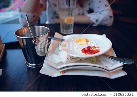 The setting beautifully showcases a partially finished meal featuring various dips and a refreshing drink The setting beautifully showcases a partially finished meal featuring various dips and a refreshing drink 118625321