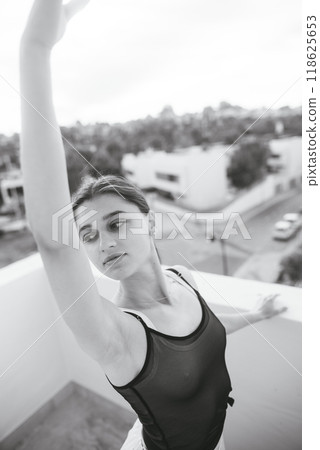 An Elegant Ballerina Graciously Posing on a Stunning Rooftop in Timeless Black and White An Elegant Ballerina Graciously Posing on a Stunning Rooftop in Timeless Black and White 118625653