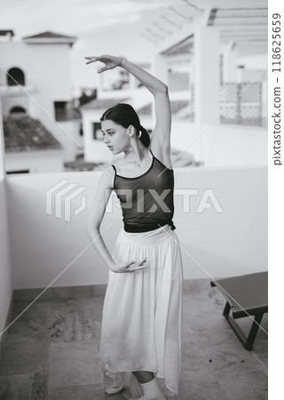 A Beautiful and Graceful Ballet Dance Pose Captured in Striking Black and White Photography A Beautiful and Graceful Ballet Dance Pose Captured in Striking Black and White Photography 118625659
