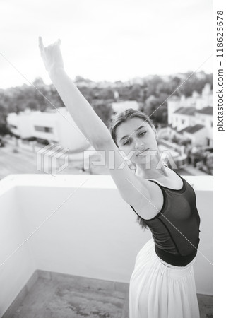 An Elegant Ballet Dance Pose captured beautifully in a Scenic Outdoor Setting amidst nature An Elegant Ballet Dance Pose captured beautifully in a Scenic Outdoor Setting amidst nature 118625678